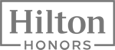 The image shows the Hilton Honors logo in gray, featuring the word "Hilton" above "Honors" enclosed in a rectangular frame.